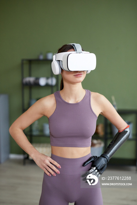 Young girl in sports clothing doing exercises at home in virtual reality glasses