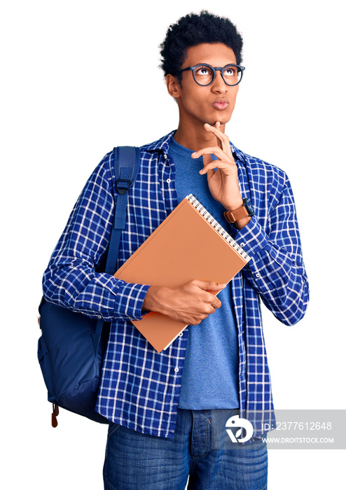 Young african american man wearing student backpack holding book thinking concentrated about doubt with finger on chin and looking up wondering