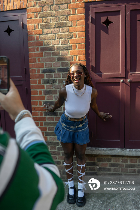 Man photographing fashionable smiling woman