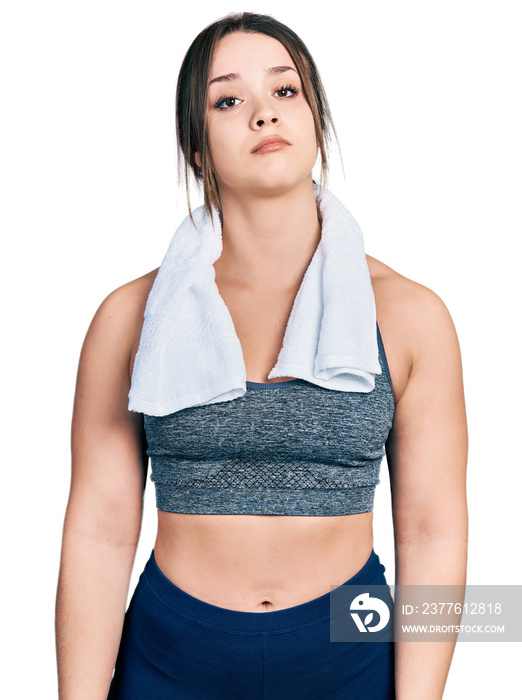 Young hispanic girl wearing sportswear and towel looking sleepy and tired, exhausted for fatigue and hangover, lazy eyes in the morning.