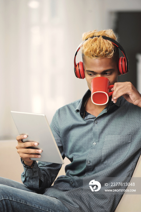 Young man reading news