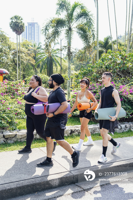 Group of friends walking together with yoga mats