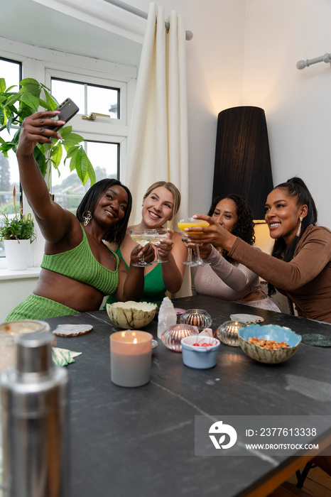 Female friends taking selfie during party