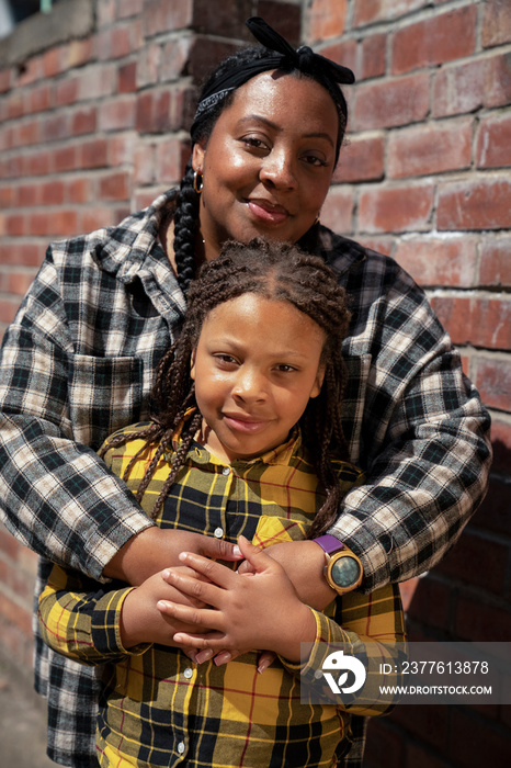 Portrait of mother embracing daughter (6-7)