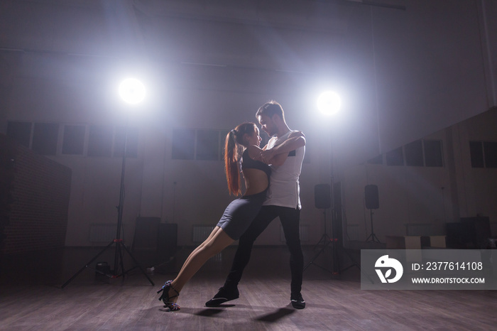 Active happy adults dancing bachata together in dance class