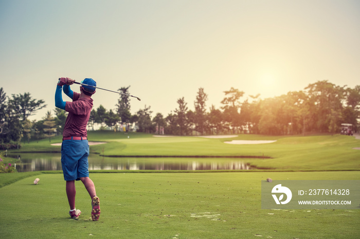 Golfers hit sweeping golf course from fairway at sunrise vintage tone