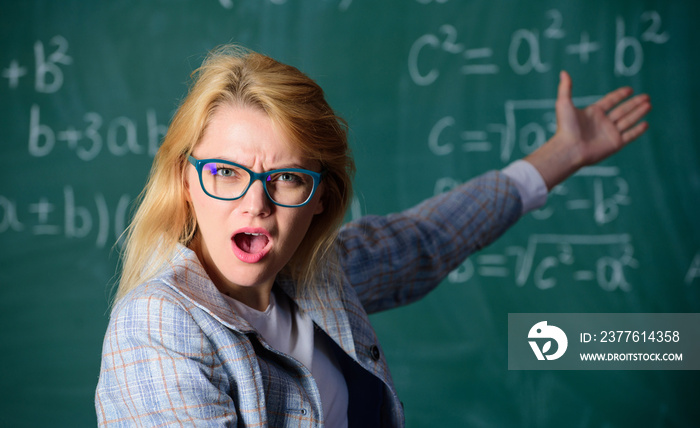 Do you know how solve that task. School education basic knowledge. Woman wear eyeglasses smart teacher classroom chalkboard background, close up. Teacher wonder about result. Solve mathematics task