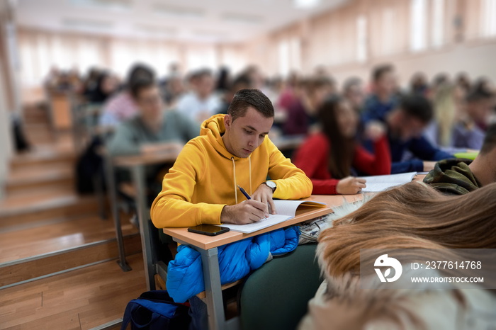 student taking notes while studying in high school