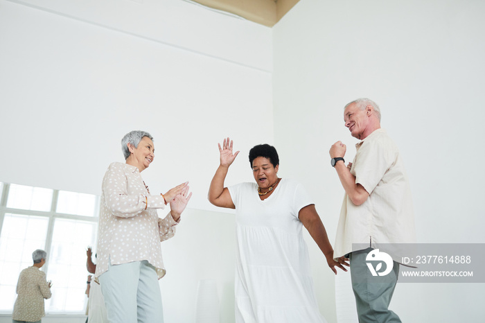 Senior people dancing to music during lesson in dance studio