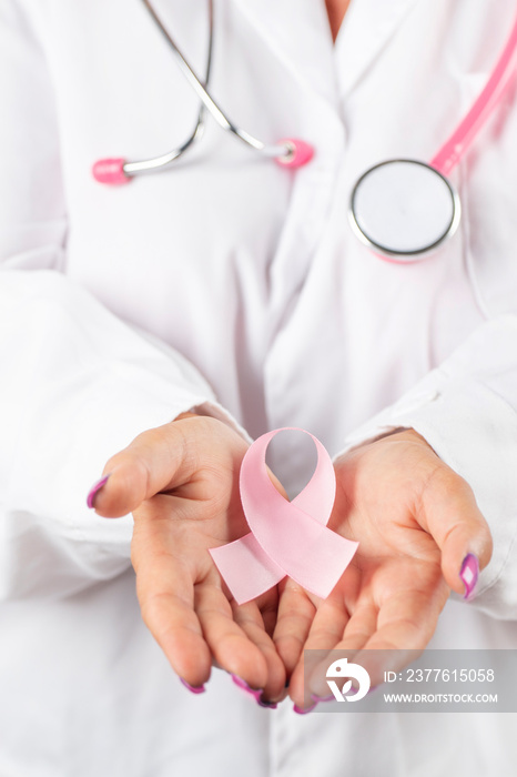 Female doctor holding breast cancer ribbon