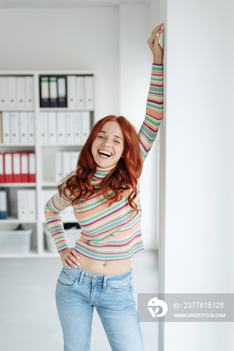 Carefree happy young woman laughing at camera