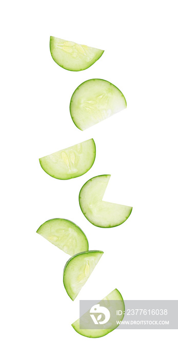Cucumber slices falling in the air isolated on white background