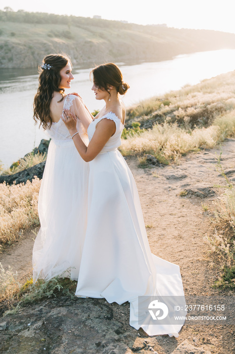 Lesbian wedding couple in white dresses