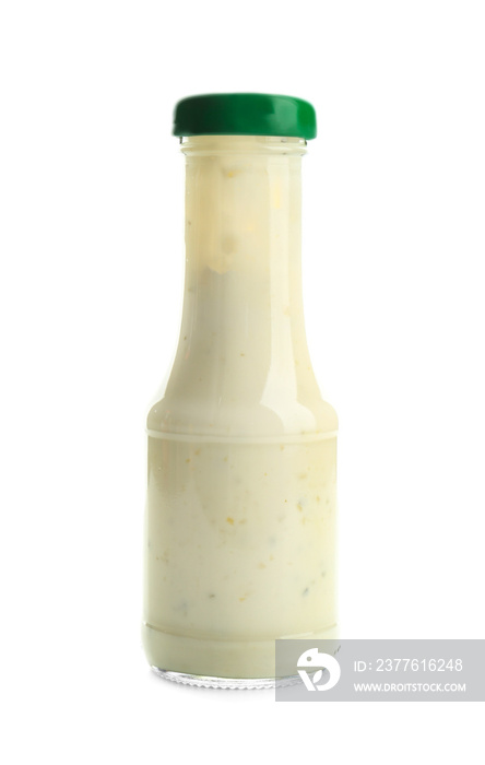 Bottle with tasty sauce for salad on white background