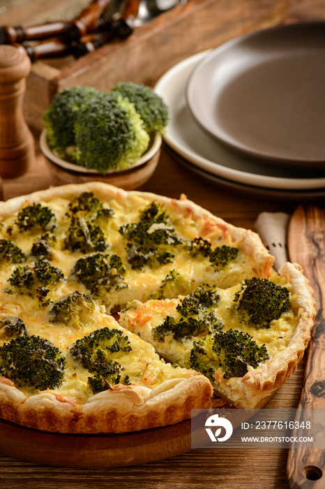 Quiche with broccoli , on wooden background.