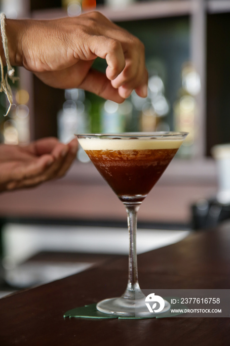 A glass of classic espresso martini on the bar counter