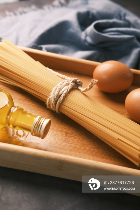 Yellow long spaghetti egg and oil on table