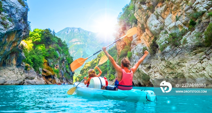 happy family having fun in canoe in the river