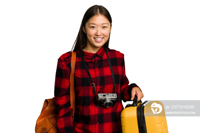 Traveler asian woman holding a suitcase isolated laughing and having fun.