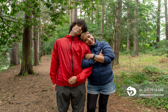 Portrait of mother and son hiking in forest