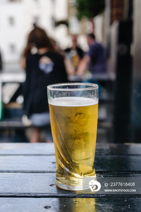 Pint of cider on an outside table at a pub.