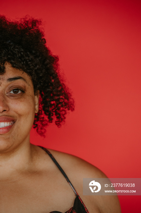 closeup of plus size afro indigenous person looking at camera smiling