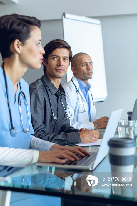 Medical team discussing at the table in hospital