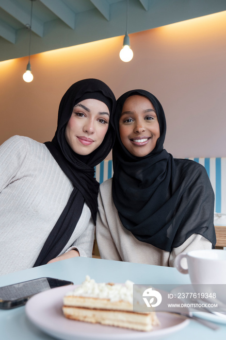 Portrait of young female friends meeting in cafe