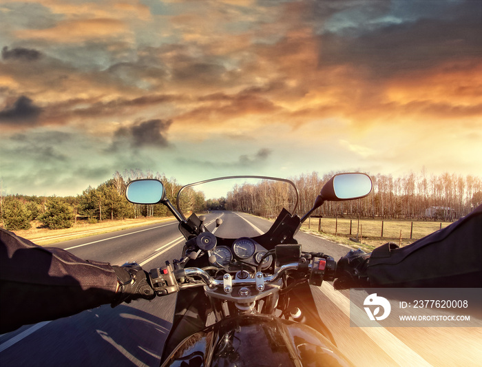 riding a motorcycle on the road on a sunny day