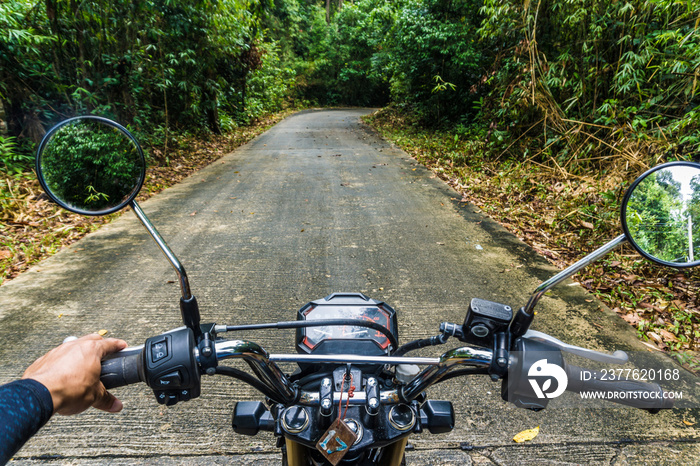 Front side of man drive motorcycle in rural country road