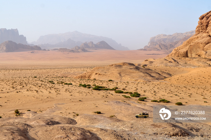 Safari jeep car in Wadi Rum desert, Jordan, Middle East, known as The Valley of the Moon. Sands, blue sky clouds. Designation as a UNESCO World Heritage Site.