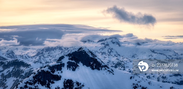 Aerial View from Airplane of Canadian Mountain Landscape in Spring time. Colorful Sunset Sky. North of Vancouver, British Columbia, Canada. Dark Moody Art Render