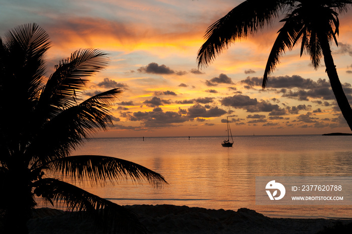 Beautiful sunset from the beach in Chub Cay, Bahamas with my sailboat Arcturus in the background.