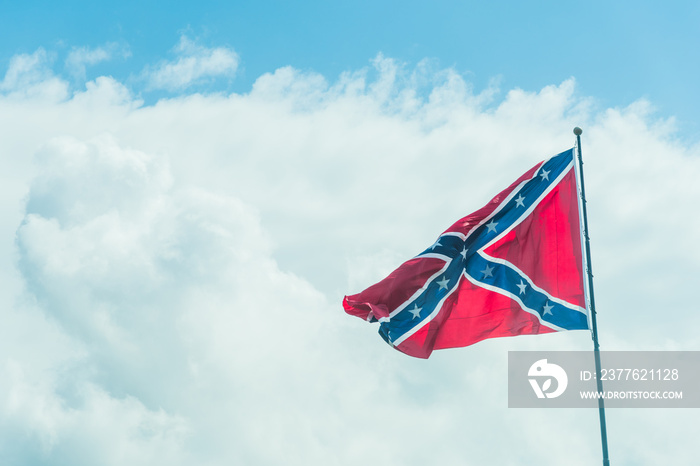 Confederate flag under a blue sky with clouds in Florida