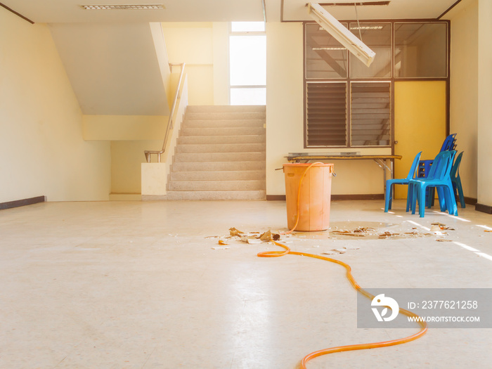 water leak drop in red tank interior office building in from ceiling and flow on terrazzo floor