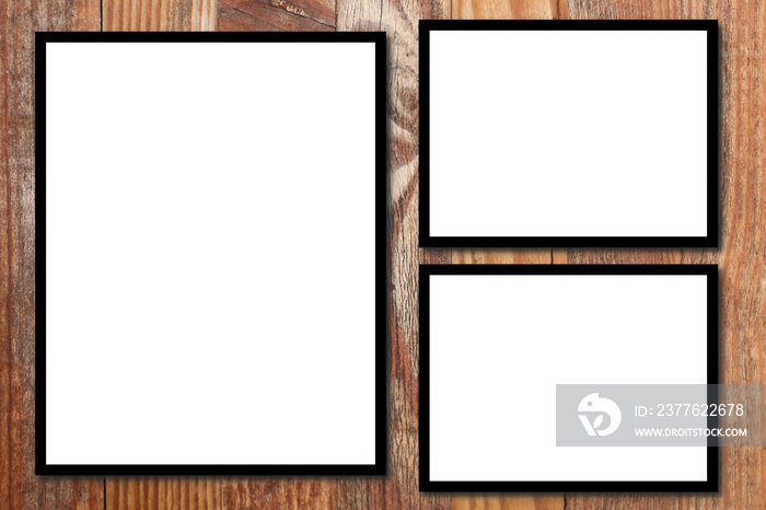 Three empty white blank photo in black frame for mockup in wooden wall background