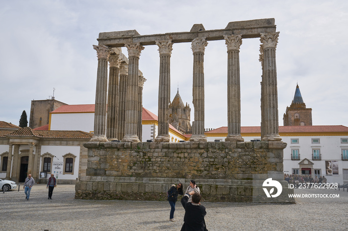 Tourists taking photos in Templo de Diana temple in Evora, Portugal