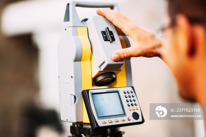 close up details of survey engineer working with total station theodolite at landscaping project