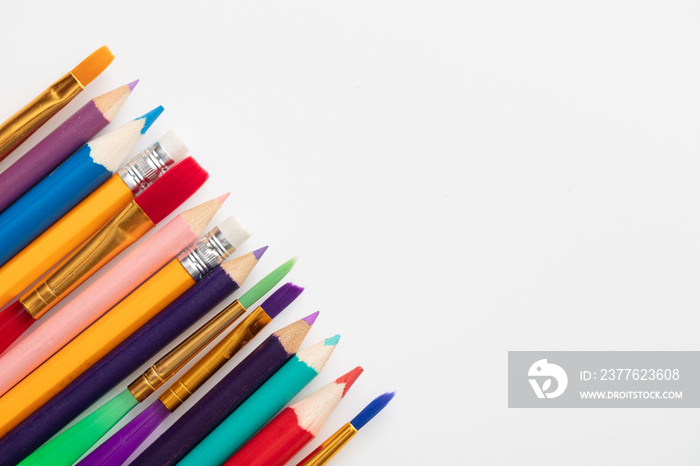 Row of school art and craft supplies on a white background