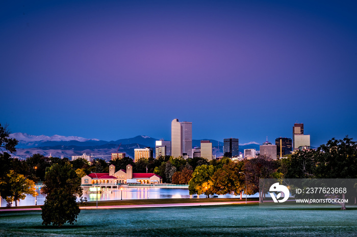 Early morning Denver Colorado skyline from City Park with Rocky Mountains in background.