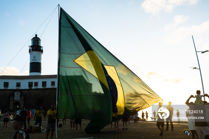 Supporters of the President of Brazil Jair Bolsonaro, place a large Brazilian flag at Farol da Barra square in Salvador