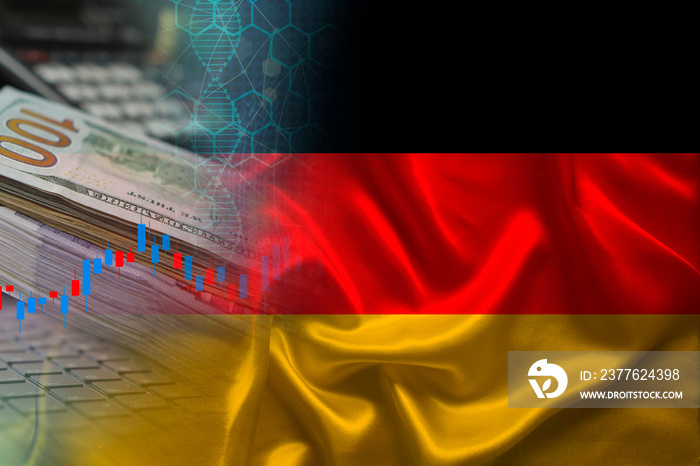 national flag of Germany on satin, dollar bills, computer, concept of global trading on the stock exchange, falling and rising prices for world currency