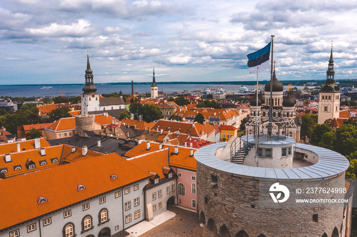 Close up view of the Estonian flag on top of the old medieval tower.