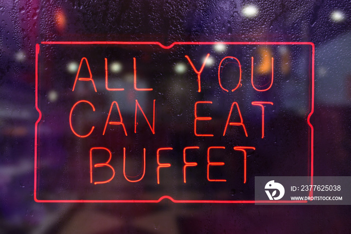All You Can Eat Buffet Neon Sign in Rainy Restaurant Window
