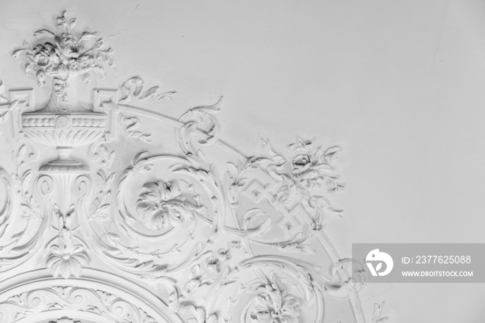 White bas-relief ceiling design elements in rococo style