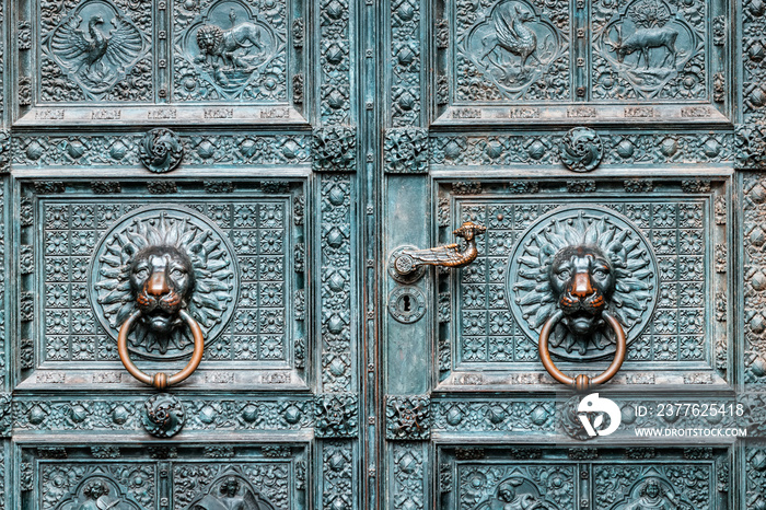 Iron old handle of decorated church or town hall door.