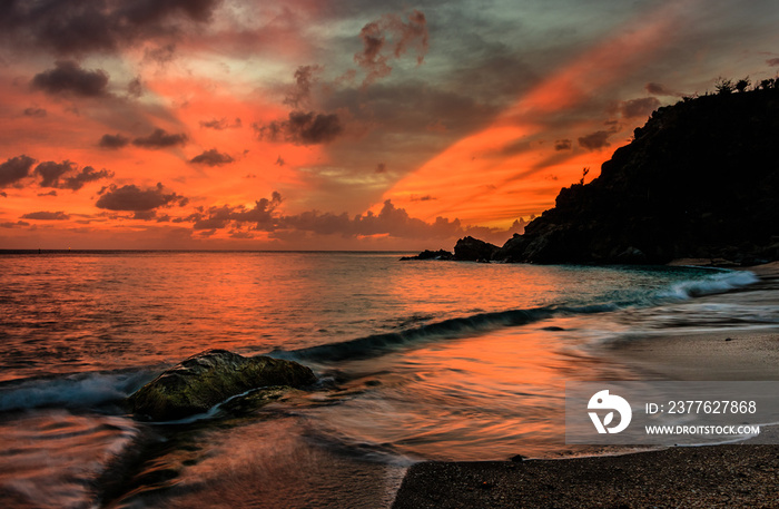 Travel photo in St. Barths, Caribbean. View of a peaceful sunset and waves on Shell Beach.