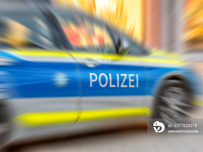 Motion blur of German police car with letters POLIZEI.