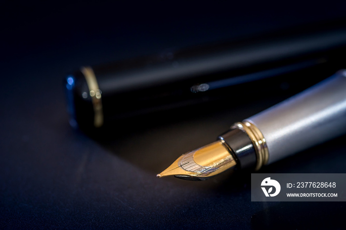 stylish ink pen for the letter  isolated on black background