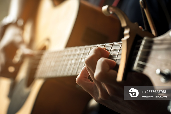 hand of guitarist and chord of guitar.